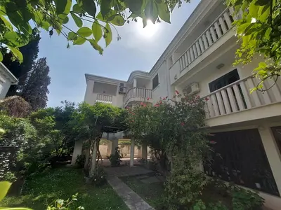 an exterior view of a building with trees and bushes at Villa Lara Budva in Budva
