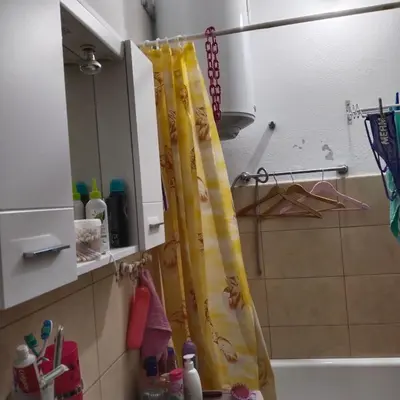 a bathroom with a shower curtain in a kitchen at Apartman ElaBi in Bar