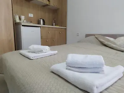 a bed with towels sitting on top of it at Apartments Skadar Lake in Vranjina