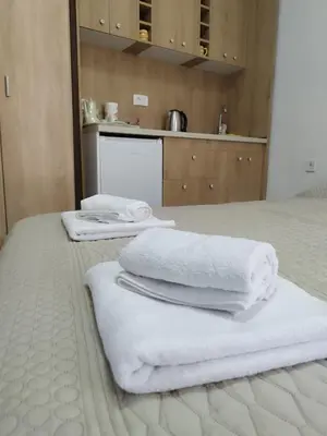 a pile of towels sitting on top of a bed at Apartments Skadar Lake in Vranjina