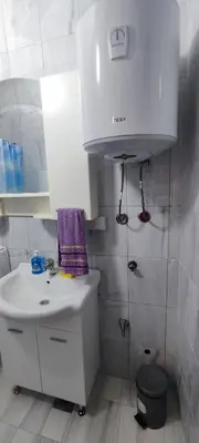 a white bathroom with a sink and a toilet at Apartments Pajo in Vranjina