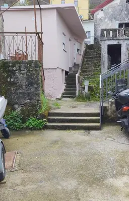 a set of stairs in front of a white building at Apartments Pajo in Vranjina