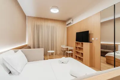 a hotel room with a bed and a tv at Twin Towers By In Property in Becici