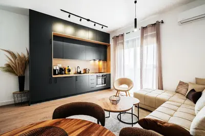a living room with a couch and a table at Twin Towers By In Property in Becici