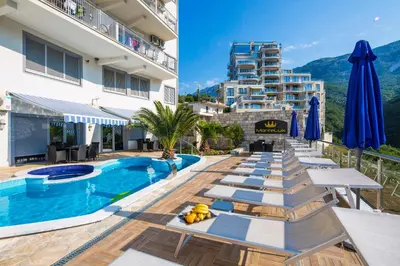 a hotel with a pool and a building at Montelux Apartments in Budva