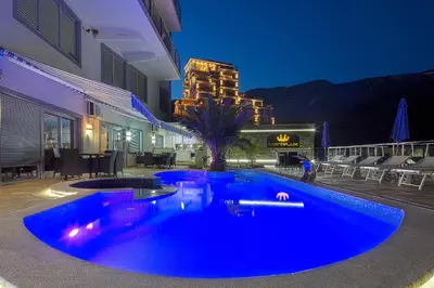a blue swimming pool in the middle of a building at Montelux Apartments in Budva