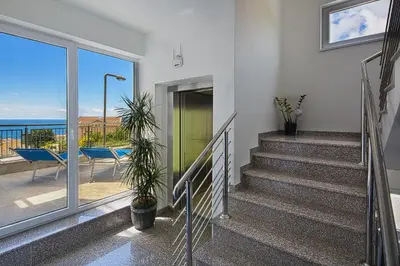 a staircase leading to a balcony with a view of the ocean at Montelux Apartments in Budva
