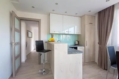 a kitchen with a counter and chairs in a room at Montelux Apartments in Budva