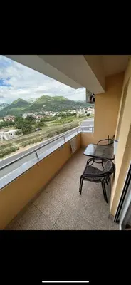a balcony with a bench and a window with a view at Stan na dan Bar in Bar, Susanj