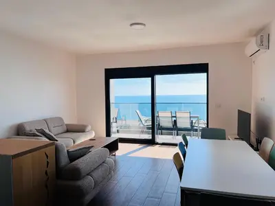 a living room with a view of the ocean at Swiss DELUXE Appartement in Dobra Voda