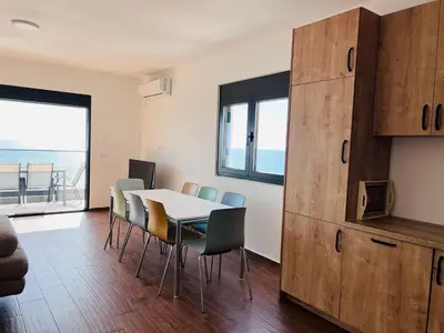 a dining room with a table and chairs at Swiss DELUXE Appartement in Dobra Voda