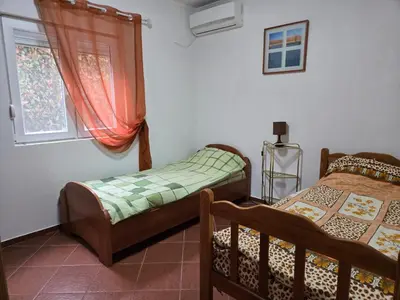 a bedroom with two beds and a window at Apartment Anna in Polje