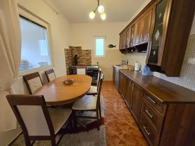 a kitchen with a wooden table and a dining room at Apartment Anna in Polje