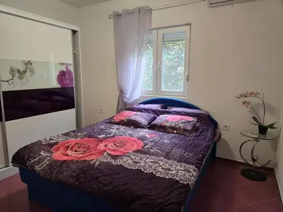 a bedroom with a bed with flowers on it at Apartment Anna in Polje
