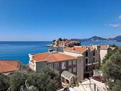 an aerial view of a town with the ocean at Sveti Stefan Family Apartments in Budva