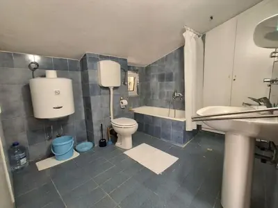 a bathroom with a toilet and a tub and a sink at Sveti Stefan Family Apartments in Budva