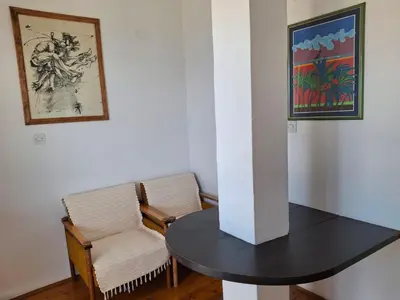 a table and a chair in a room at Sveti Stefan Family Apartments in Budva