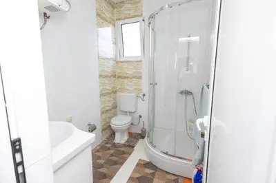 a bathroom with a shower and a toilet and a sink at LuxuryHomeUlcinj2 in Ulcinj
