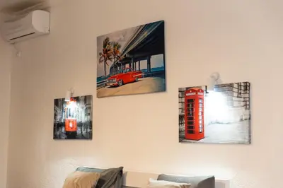 a room with four pictures of a red phone booth and a red telephone box at LuxuryHomeUlcinj2 in Ulcinj
