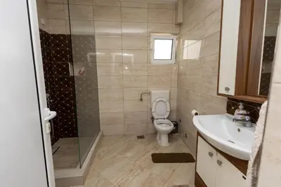 a bathroom with a toilet and a shower and a sink at LuxuryHomeUlcinj2 in Ulcinj