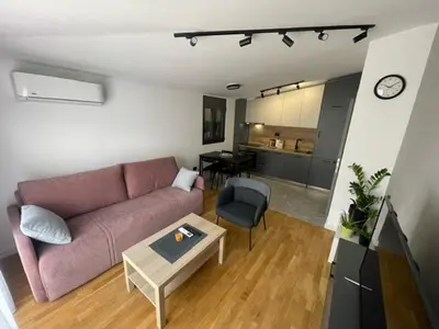 a living room with a couch and a table at Apartment Tara in Podgorica