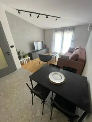 a living room with a table and a couch at Apartment Tara in Podgorica