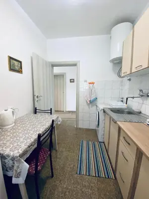 a small kitchen with a table and a kitchen gmaxwell gmaxwell gmaxwell gmaxwell gmaxwell at Guest house in Sutomore
