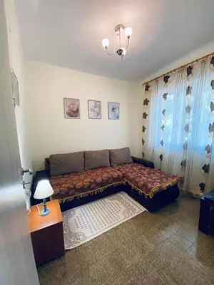 a living room with a couch and a table at Guest house in Sutomore