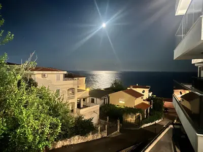 a view of the ocean from the balcony of a house at Mellas Premium Apartment in Dobra Voda
