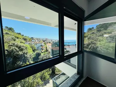 a room with windows with a view of the ocean at Mellas Premium Apartment in Dobra Voda