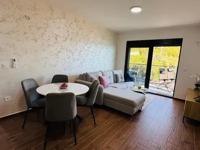 a living room with a couch and a table at Mellas Premium Apartment in Dobra Voda