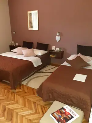 a bedroom with two beds and a book at Apartments Ant in Budva