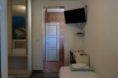 a small room with a bed and a television at Kuca Radovic in Petrovac na Moru