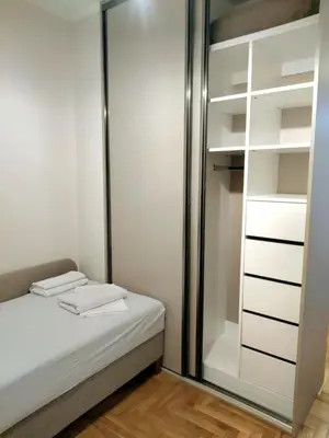 a room with a bed and a glass closet at Felicia Apartments in Budva