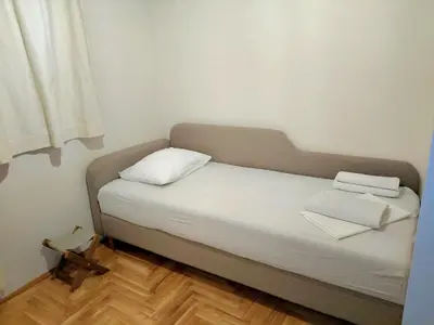 a bed with two pillows on it in a room at Felicia Apartments in Budva