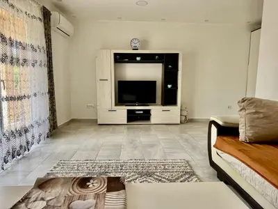 a living room with a tv and a couch at Valentina Apartman in Radanovići