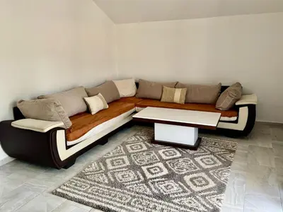 a living room with a couch and a table at Valentina Apartman in Radanovići