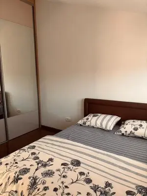 a bedroom with a bed with a mirror and a bedspread at My big house in Kotor