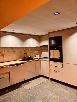 a kitchen with white cabinets and a black refrigerator at My big house in Kotor