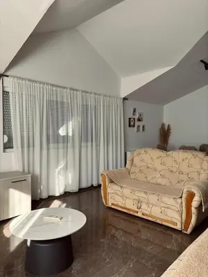 a living room with a couch and a table at My big house in Kotor