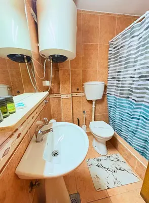 a bathroom with a sink and a toilet at Central Hotel & Restaurant in Budva