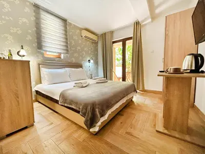 a bedroom with a bed in a room at Central Hotel & Restaurant in Budva