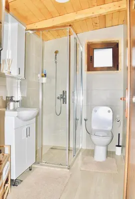 a bathroom with a shower and a toilet at Wooden House Šapat sela in Podgorica