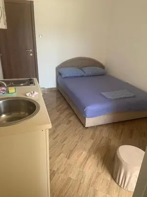 a small room with a bed and a sink at Apartmani Duretic in Sutomore