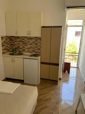 a kitchen with a sink and a counter top at Apartmani Duretic in Sutomore