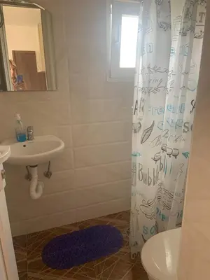 a bathroom with a sink and a shower curtain at Apartmani Duretic in Sutomore
