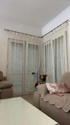 a living room with a bed and some windows at Vila Dior Donji Stoj in Donji Štoj