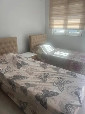 a bedroom with two beds with a flowered bedspread at Vila Dior Donji Stoj in Donji Štoj