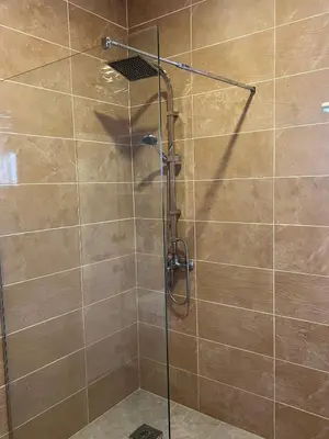 a shower with a glass door in a bathroom at Vila Dior Donji Stoj in Donji Štoj