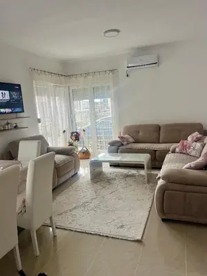 a living room with two couches and a table at Vila Dior Donji Stoj in Donji Štoj